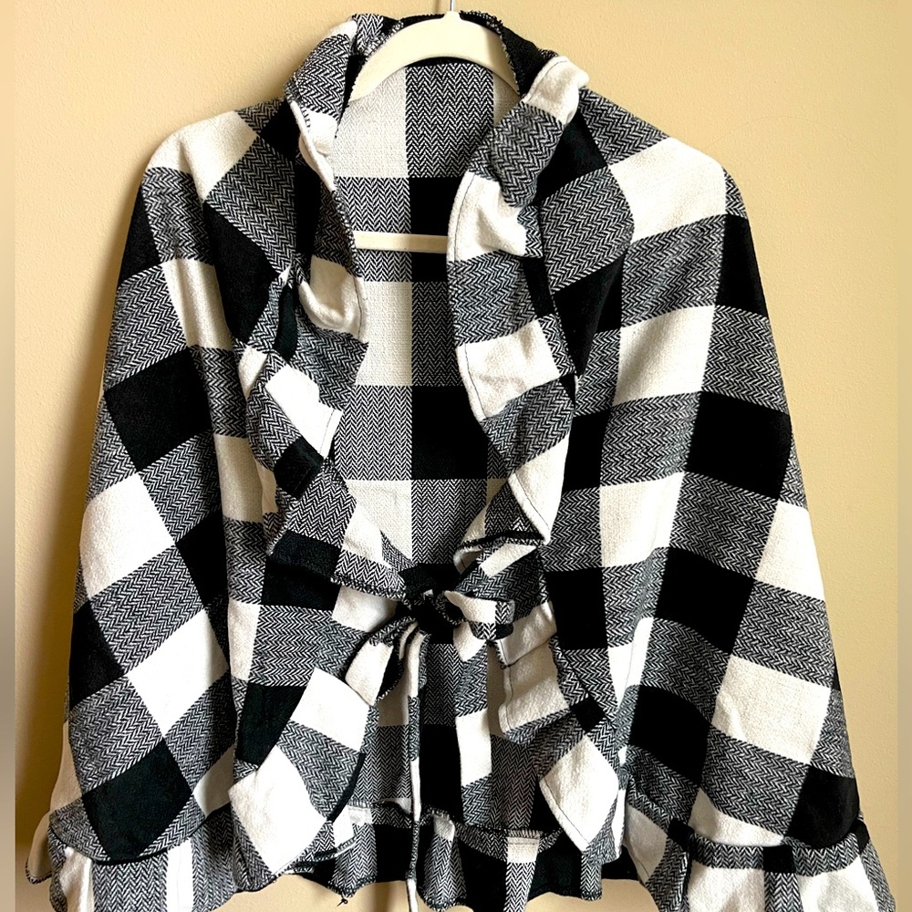Beautiful buffalo plaid wrap with ruffles and ties in front. Boutique purchased.
